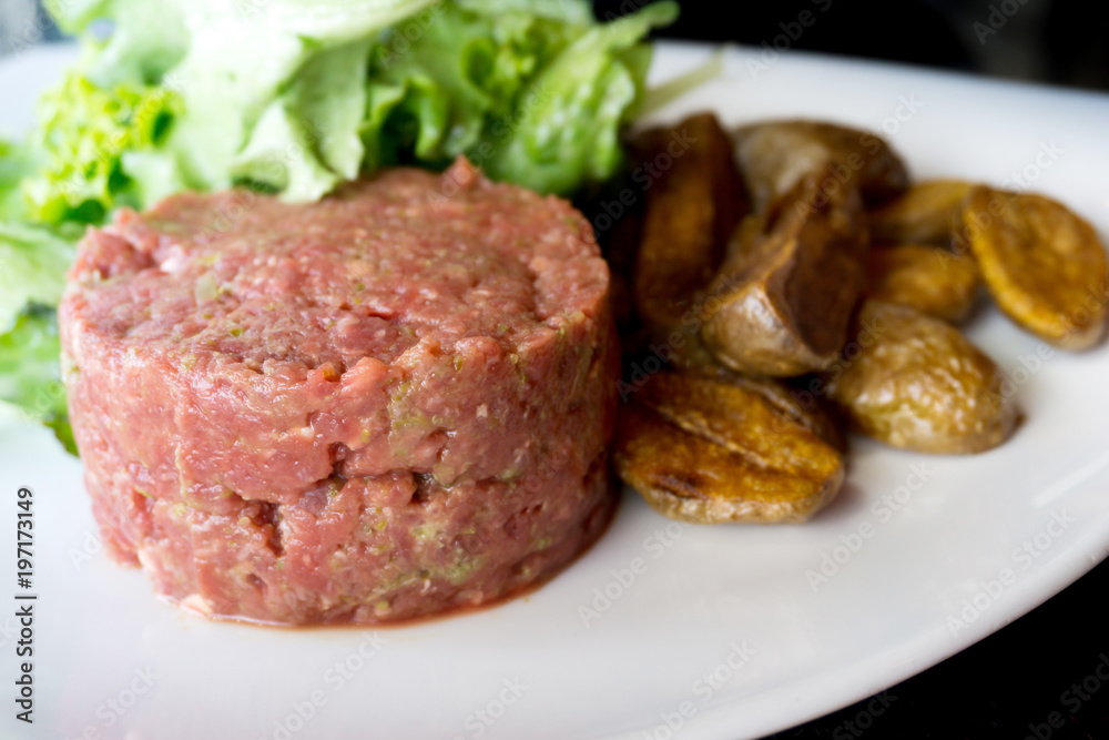 tasty Steak tartare (Raw beef) - classic steak tartare on white plate tasty Steak tartare (Raw beef) - classic steak tartare on white plate