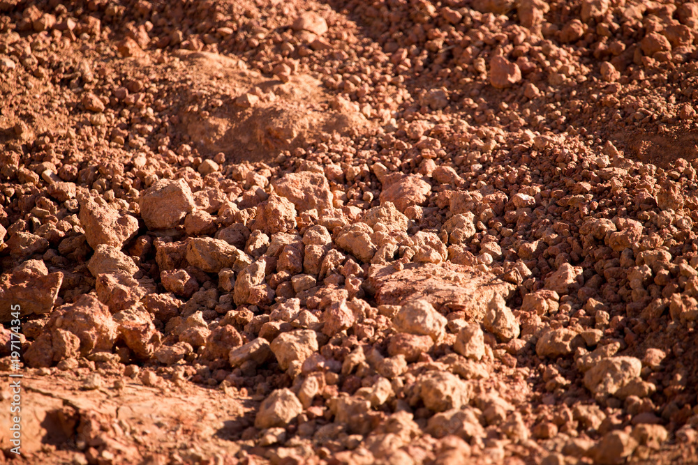 Fototapeta premium Red clay soil on nature as a background