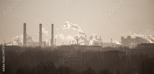 Smoke from the pipes of an industrial plant in the morning