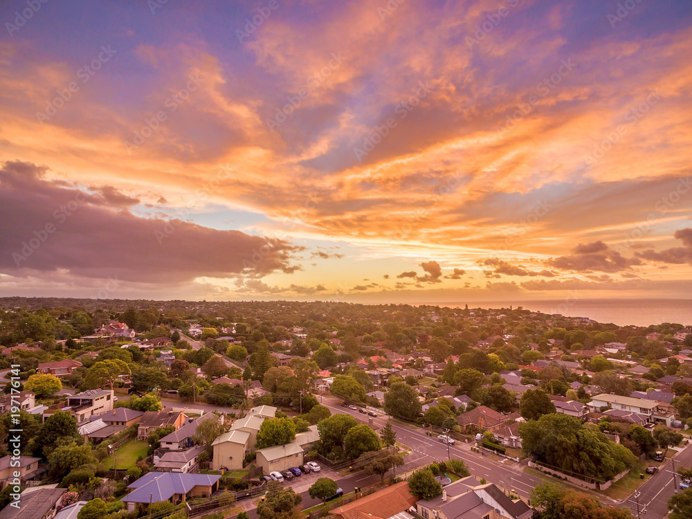 Aerial view of glowing sunset over suburban area