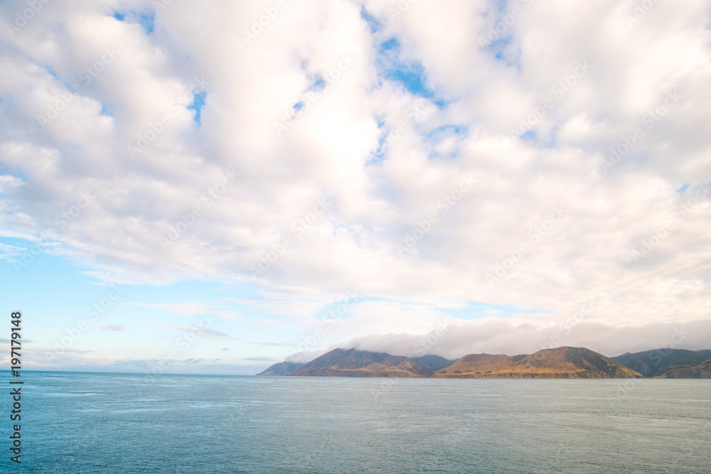 Landscape of the Mountain and sea with cloudy in the morning. View from the ferry to  South Island, New Zealand.