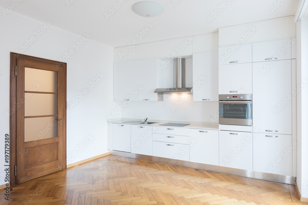 Kitchen in newly renovated open space with wooden floors