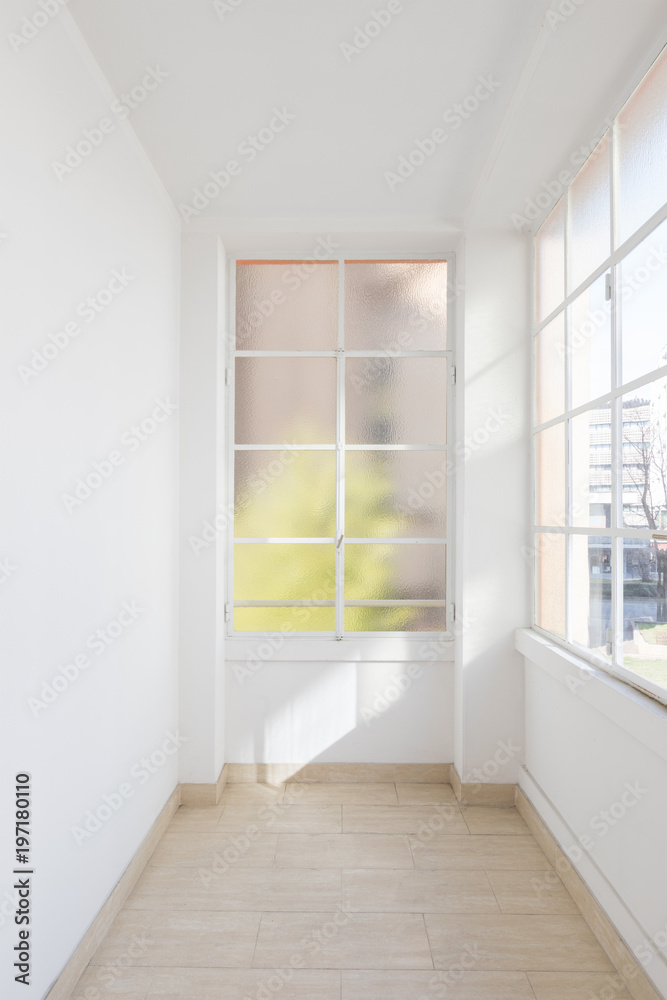 Fototapeta premium Bright empty corridor with large windows