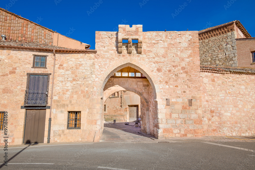 exterior medieval arch in public street, ancient gate and main access to old town, famous landmark and monument in Ayllon village, Segovia, Spain, Europe
