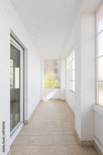 Bright empty corridor with large windows