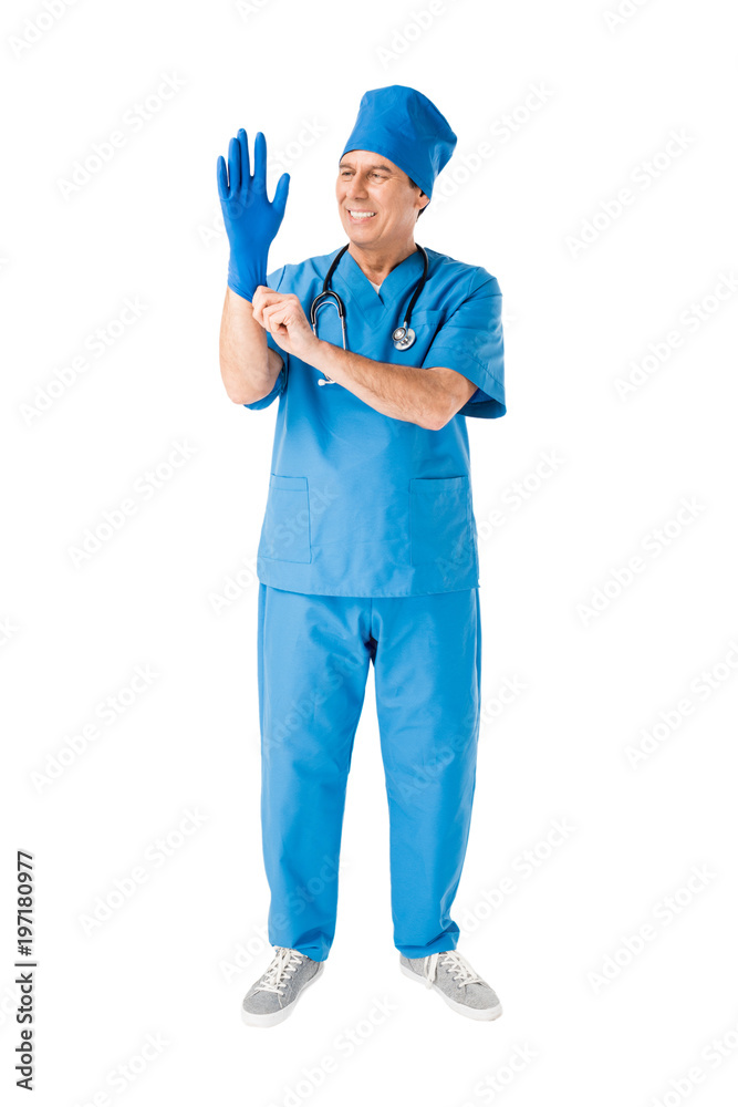 Smiling male doctor wearing medical glove isolated on white
