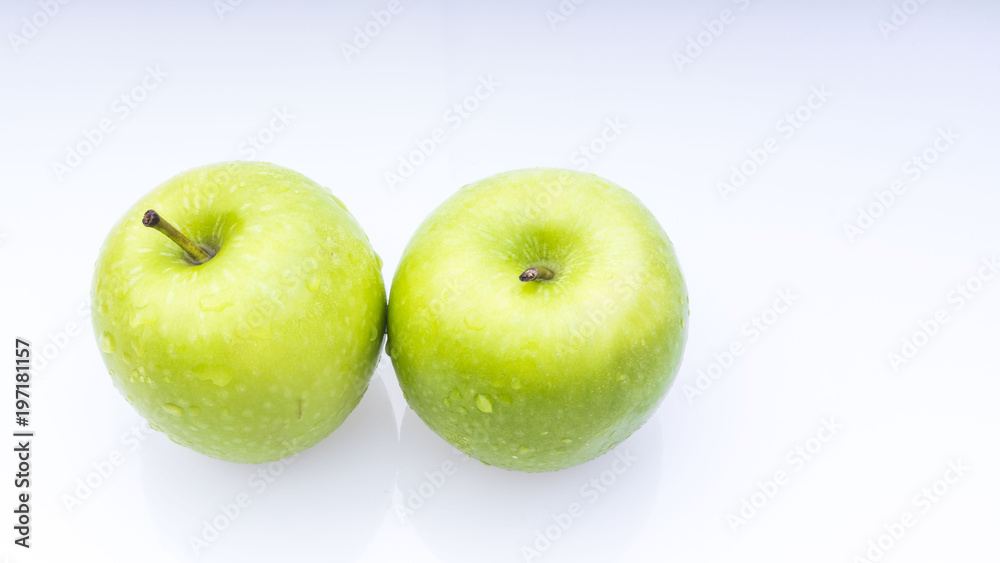 Closeup of green apple with water drops on white background. Selective focus. Closeup of green apple with water drops on white background. Selective focus.
