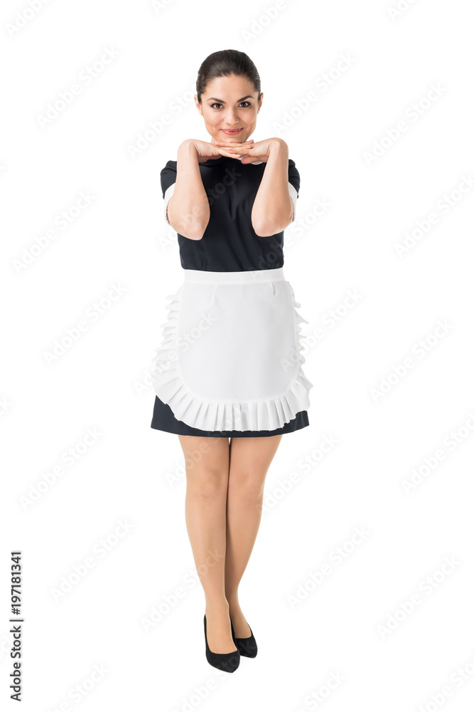 Smiling maid in professional uniform with hands by face isolated on white Smiling maid in professional uniform with hands by face isolated on white