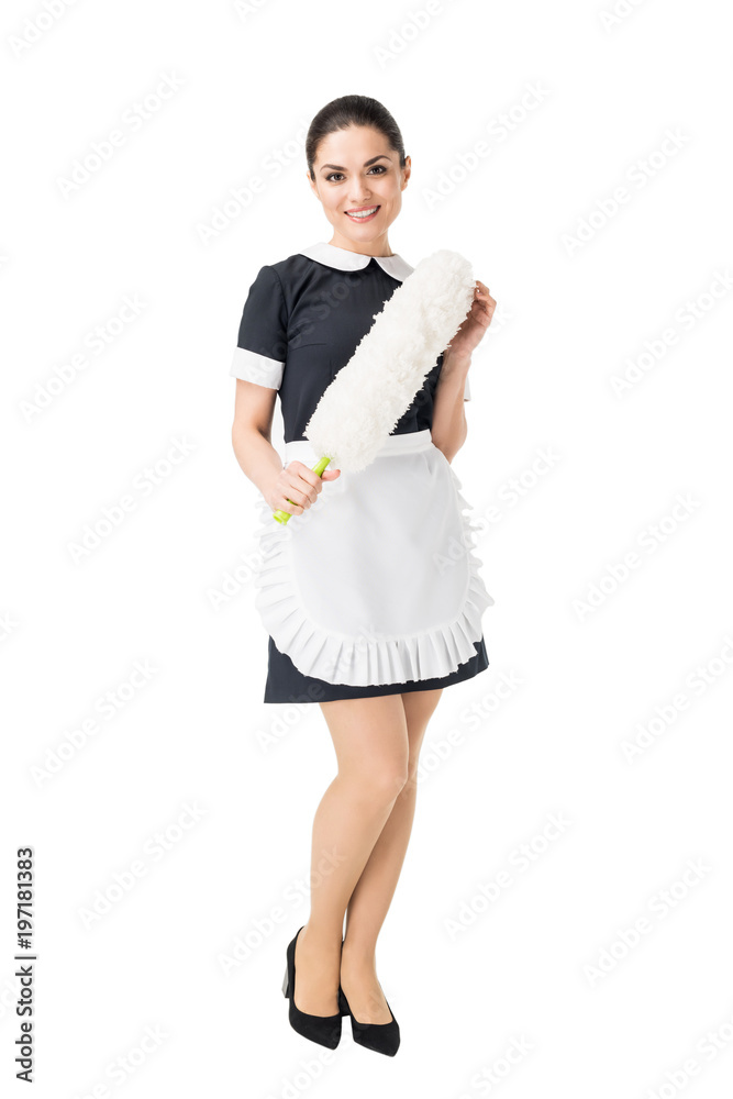 Young maid in professional uniform holding duster isolated on white Young maid in professional uniform holding duster isolated on white