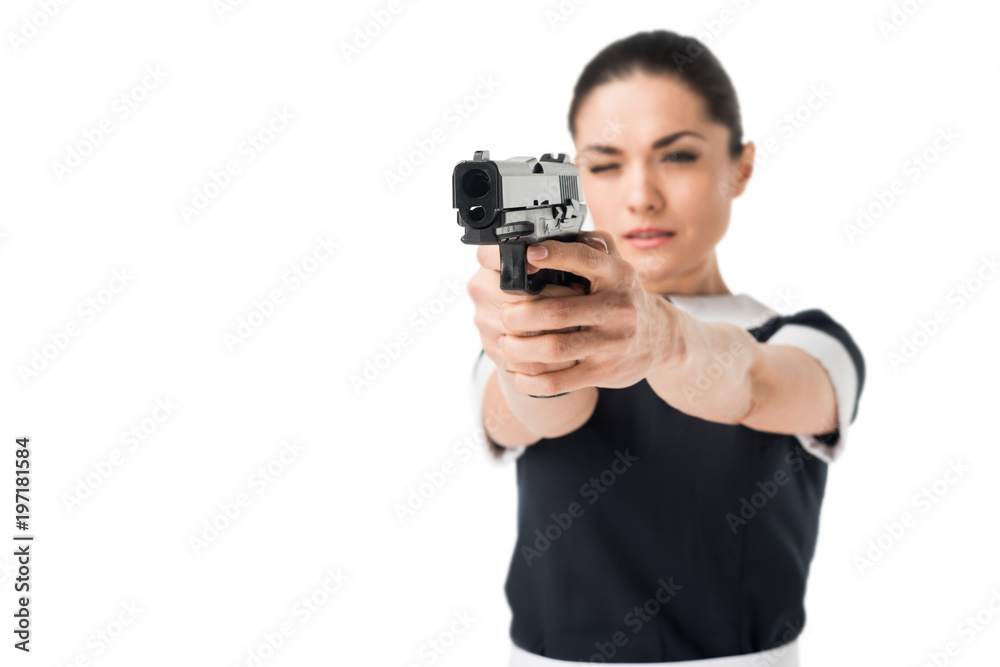 Young woman in maid uniform aiming gun isolated on white Young woman in maid uniform aiming gun isolated on white