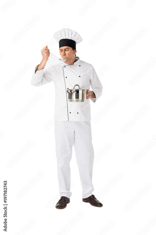Smiling chef with pan tasting food isolated on white