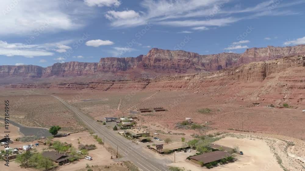 Aerial of buildings and a road near buttes