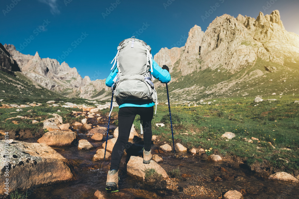 backpacking woman hiker walking on beautiful mountains