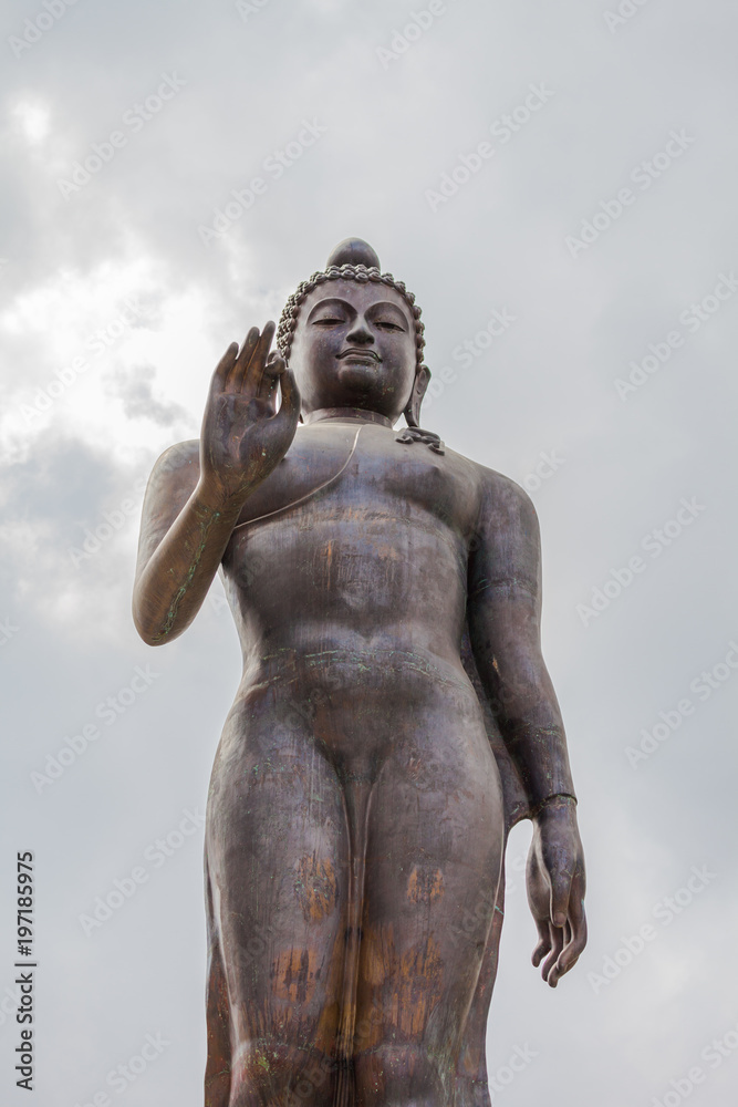 standing Buddha statue on Doi Pukha above Golden Triangle at view point of Kong river in Chiang Rai Thailand