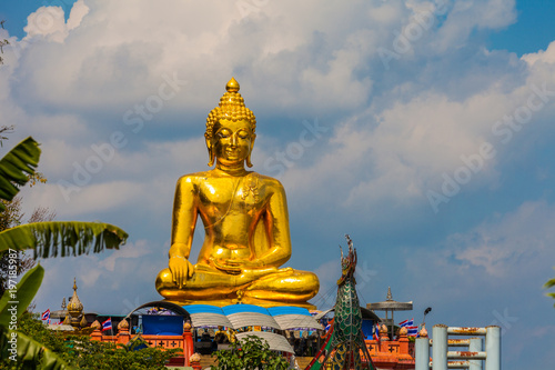 sitting golden big Buddha statue at Golden Triangle at view point of Kong river in Chiang Rai Thailand