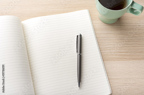 blank notebook with pencil on wooden desk