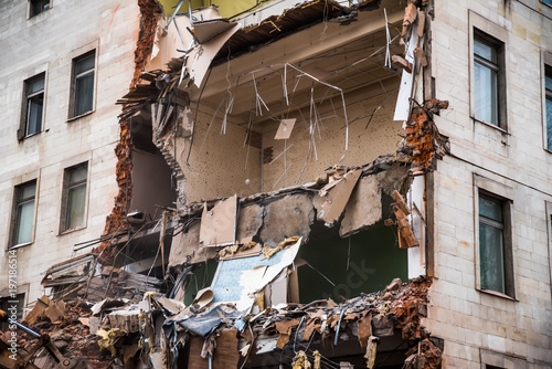 Demolition of a building with floors fragment. Destroyed structure, broken floors.