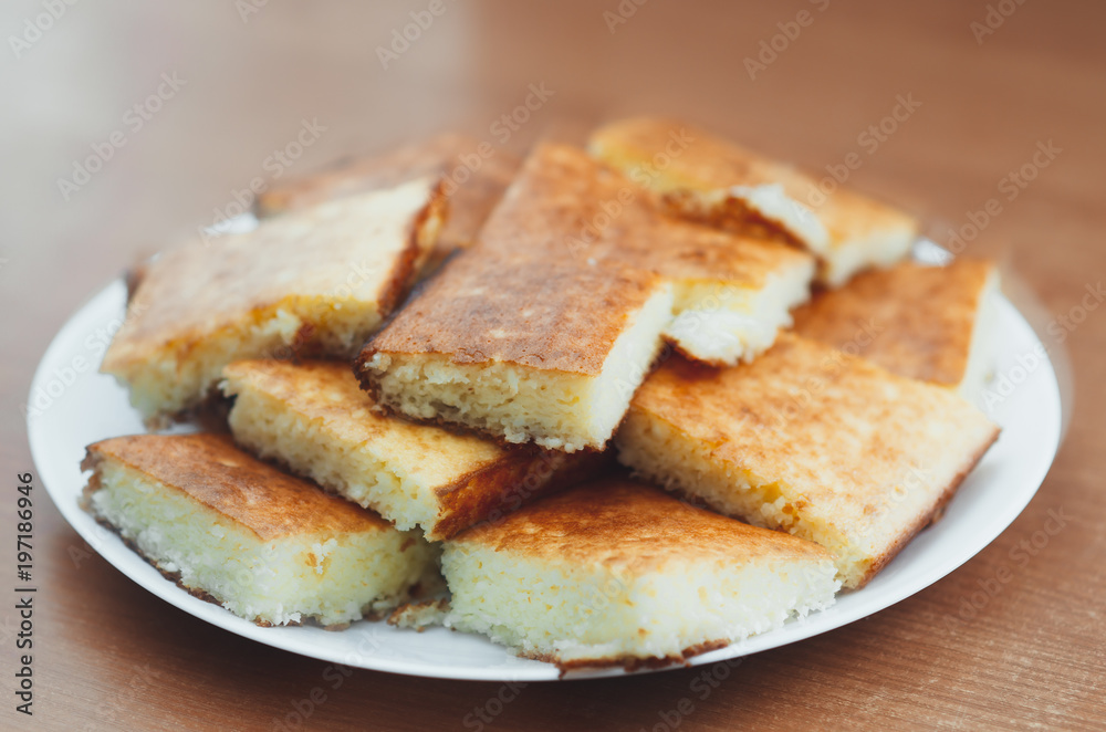 beautiful casserole on a plate of Golden-colored cottage cheese sweet tasty beautiful casserole on a plate of Golden-colored cottage cheese sweet tasty