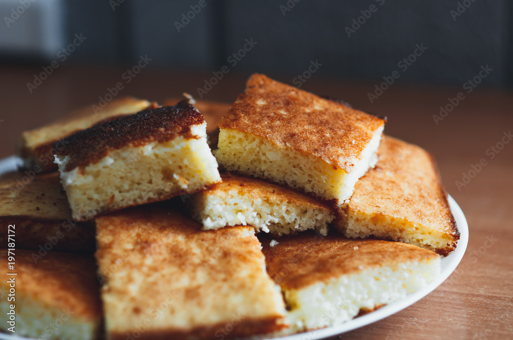 beautiful casserole on a plate of Golden-colored cottage cheese sweet tasty beautiful casserole on a plate of Golden-colored cottage cheese sweet tasty