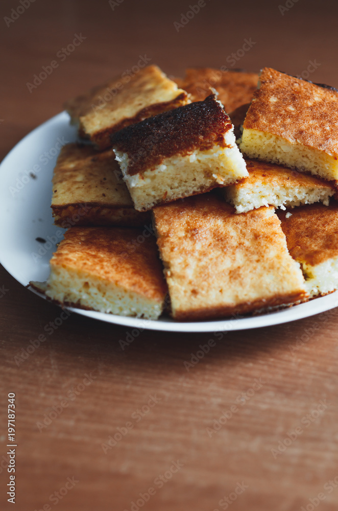 beautiful casserole on a plate of Golden-colored cottage cheese sweet tasty beautiful casserole on a plate of Golden-colored cottage cheese sweet tasty