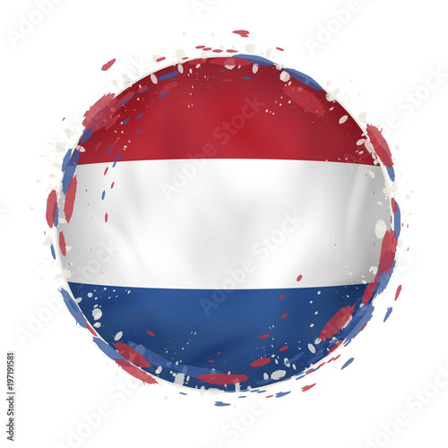 Round grunge flag of Netherlands with splashes in flag color.