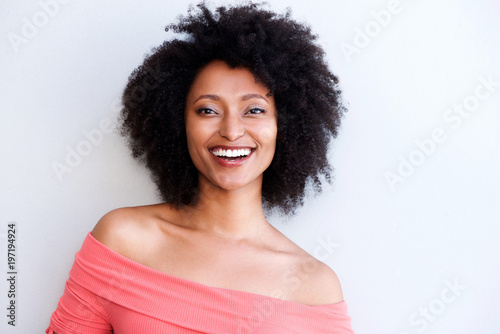 Close up pretty young african woman smiling against white background