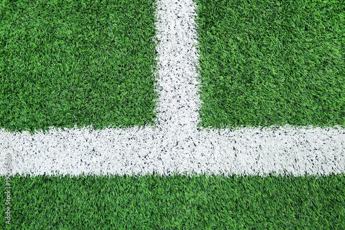 Line on Soccer field or football field texture background. White lines on green grass, symbol to the way to success. Sport and business background concept.