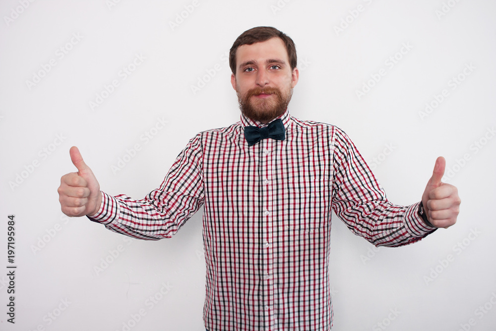 Young caucasian bearded man showing thumb up sign. In studio with white background and copyspace Young caucasian bearded man showing thumb up sign. In studio with white background and copyspace