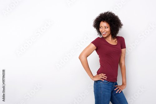 stylish female fashion model posing against white background and looking away