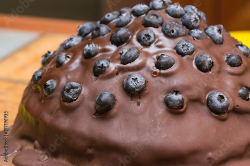 Chocolate cake made of chocolate pancakes with glaze, with blueberries. Vintage style. photo