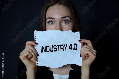 In the hands of a businessman a scrap of paper with the inscription:INDUSTRY 4.0