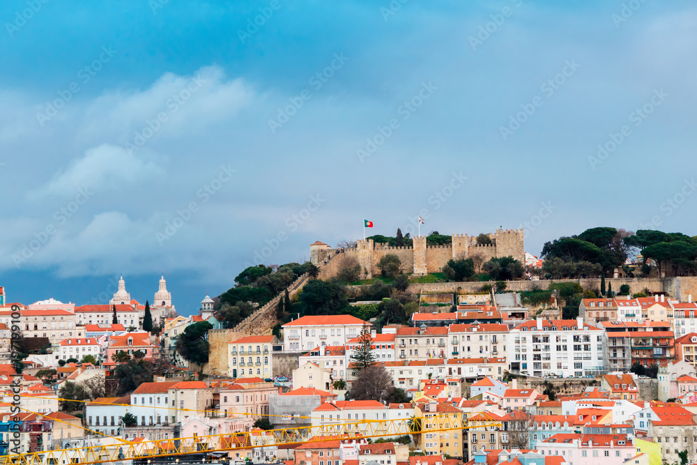 Lisbon cityscape with  medieval So Jorge Castle occupying a commanding hilltop.