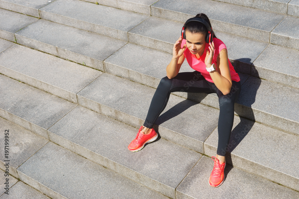 Young, fit and sporty woman preparing for urban jogging. Young, fit and sporty woman preparing for urban jogging.