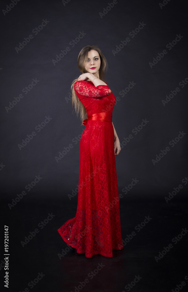Portrait of a beautiful girl in a red dress.