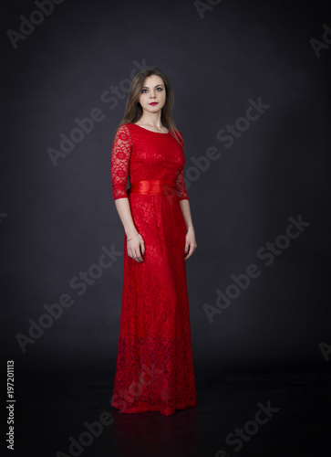 Portrait of a beautiful girl in a red dress.