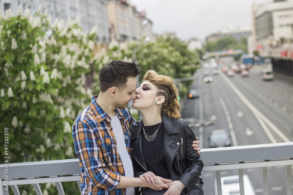 © yurolaitsalbert - portrait of loving couple standing on bridge in big city