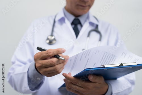 Male doctor writing prescription photo