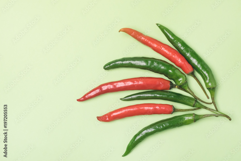 Colorful Mix of Chili Pappers on Green Background Flat Lay Top View Copy Space