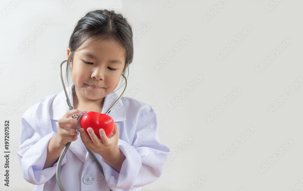 Asian girl playing as a doctor care healthy heart Asian girl playing as a doctor care healthy heart