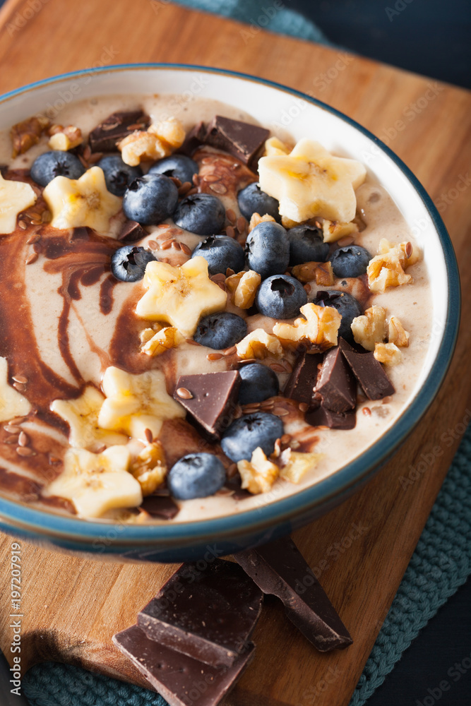 healthy banana smoothie bowl with blueberry chocolate walnuts