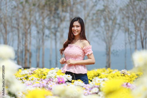 beautiful woman in chrysanthemum glower garden