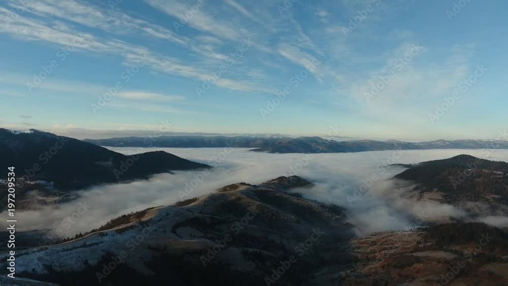 Aerial View. Flying over the high mountains in beautiful clouds . Aerial camera shot Aerial View. Flying over the high mountains in beautiful clouds . Aerial camera shot