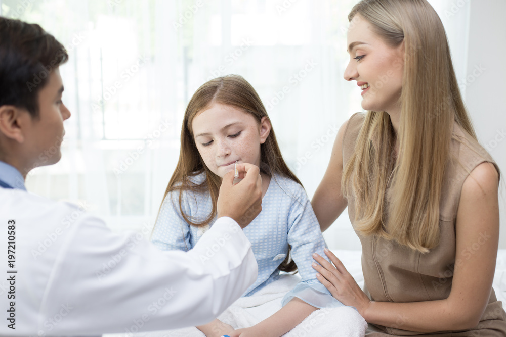 Male doctor examining inside girl mouth in clinic. People with health care and medical concept Male doctor examining inside girl mouth in clinic. People with health care and medical concept