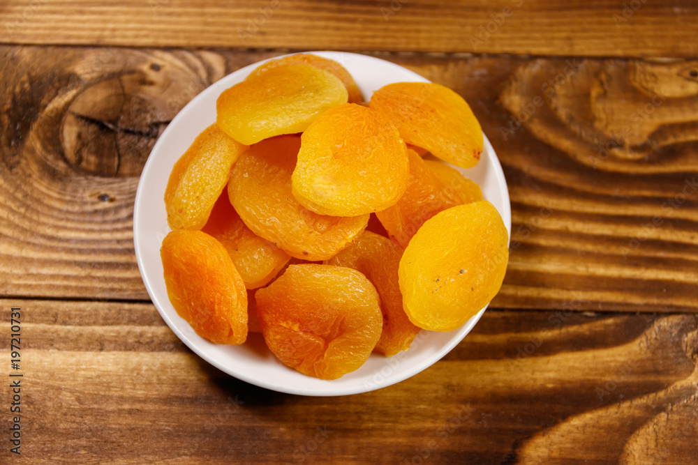 Dried apricots on wooden table. Top view