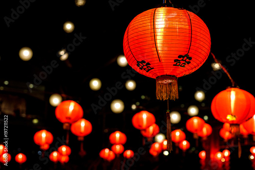 a spattering of red Chinese paper lanterns all lit up for Chinese New Year