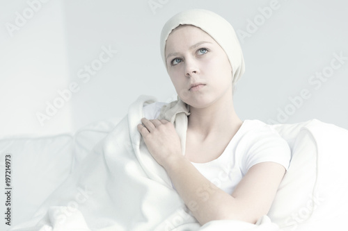 Woman sitting under blanket