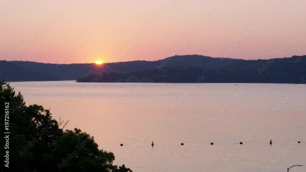 A Soft Sunlight Reflects Off A Lake