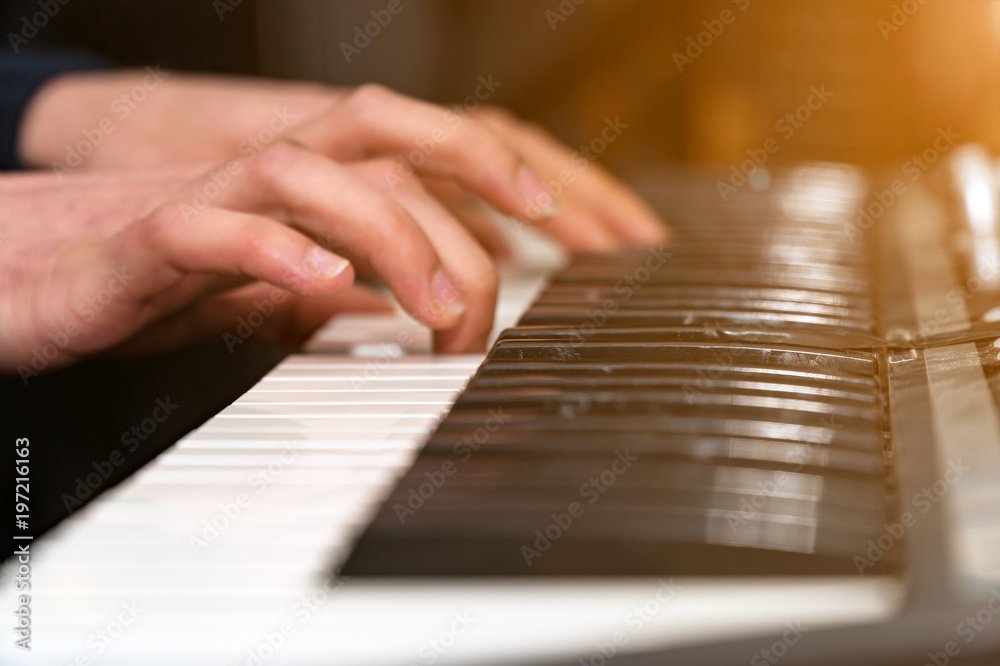 Hands of a pianist close-up. Plays on the synthesizer. Selective focus