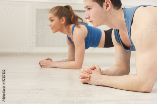 Fitness couple plank training indoors