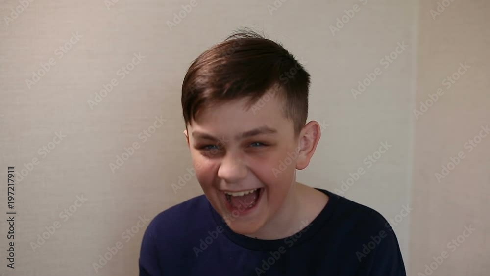 smiling laughing boy portrait in blue t-shirt smiling laughing boy portrait in blue t-shirt
